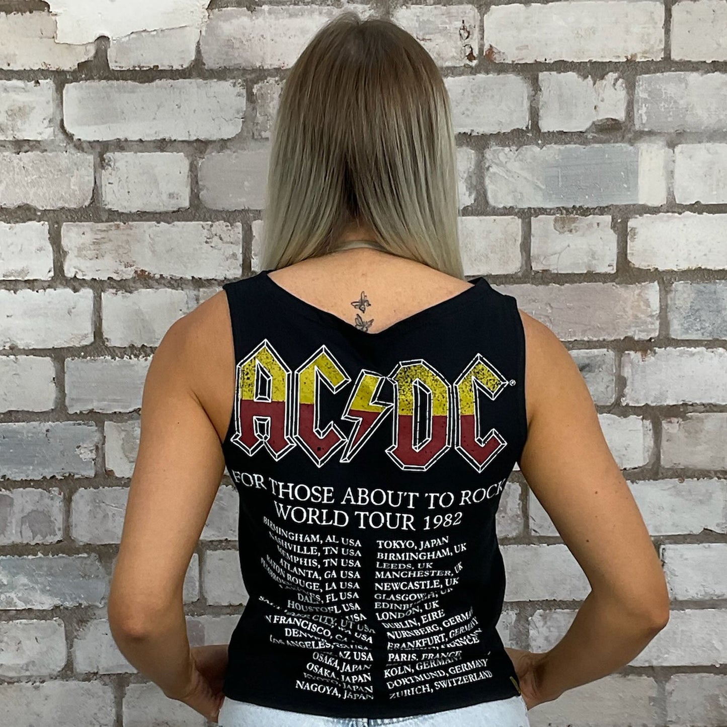 Graphic tshirt recycled into sleeveless Slash Neck vest top, sustainable upcycled fashion, British recycled grunge brand, slow fashion, Punk Rock music style graphic tshirt upcycled by Unwantees, ACDC 1982 Tour Photo tshirt upcycled in the UK by unwantees. Sustainable upcycled fashion. Graphic tshirt upcycled by Unwantees recycled tshirt otherwise destined for landfill.