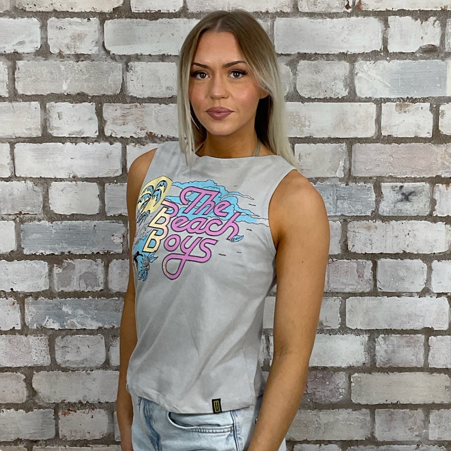 The Beach Boys graphic tshirt recycled into sleeveless vest top, sustainable upcycled fashion, British recycled fashion brand, slow fashion, eco conscious band graphic tshirt upcycled by Unwantees, recycled tshirt otherwise destined for landfill. Rock music style graphic tshirt upcycled by Unwantees, Slash Neck tank top, upcycled in the UK by unwantees. Sustainable upcycled fashion