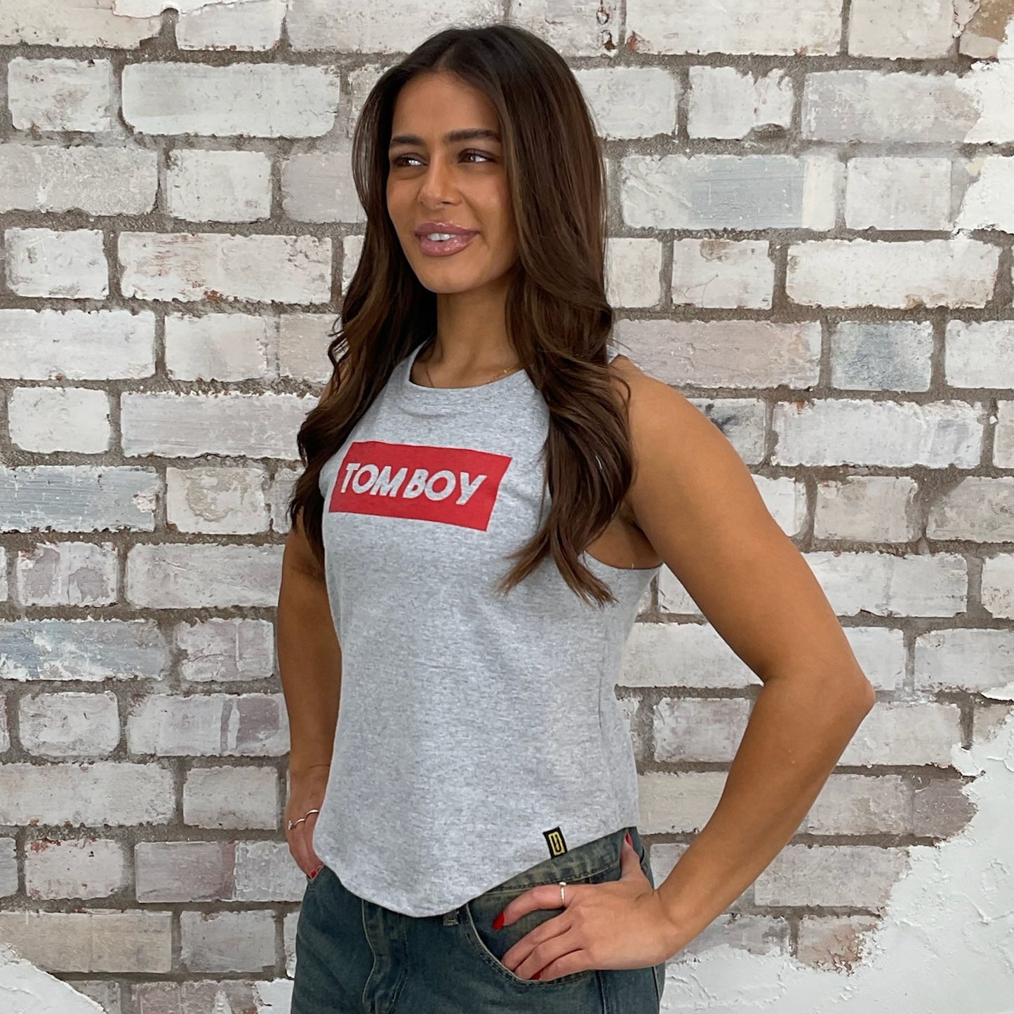 Graphic print tshirt recycled into sleeveless vest top, sustainable upcycled fashion, Tomboy recycled fashion brand, slow fashion, eco conscious band graphic tshirt upcycled by Unwantees, recycled tshirt otherwise destined for landfill. Rock music style graphic tshirt upcycled by Unwantees, Grey Racerback tank top, upcycled in the UK by unwantees. Sustainable upcycled fashion