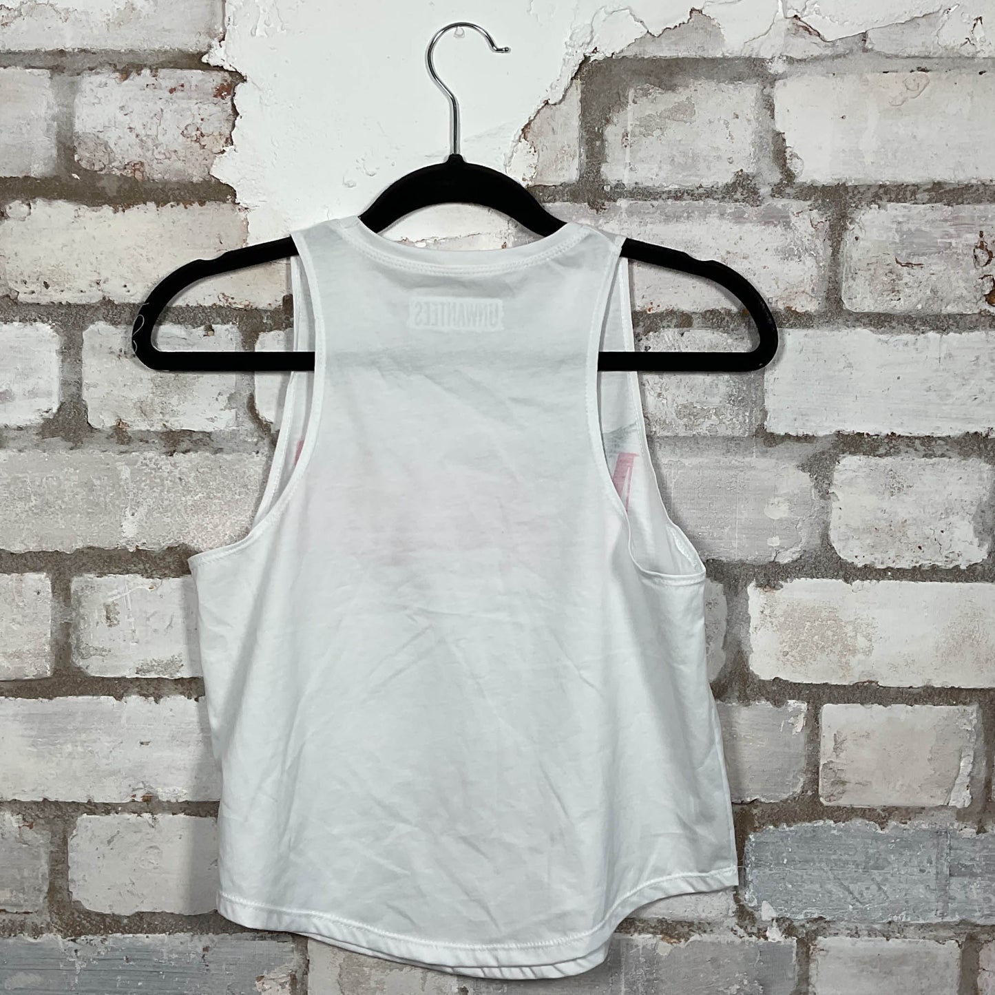Rear View of Nirvana classic logo in hot pink on a white Racerback Vest Top upcycled by Unwantees, sustainable fashion made in Great Britain from vintage graphic tshirt