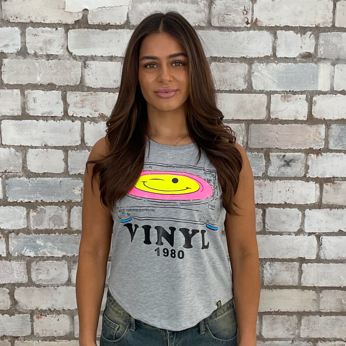 1980s themed graphic tshirt upcycled by Unwantees, eco conscious fashion graphic tshirt upcycled by Unwantees, recycled tshirt otherwise destined for landfill. Graphic tshirt recycled into sleeveless vest top, sustainable upcycled fashion, British recycled acid house print slow fashion, Punk Rock music style graphic tshirt upcycled by Unwantees, Racerback tank top, upcycled in the UK by unwantees. Sustainable upcycled fashion