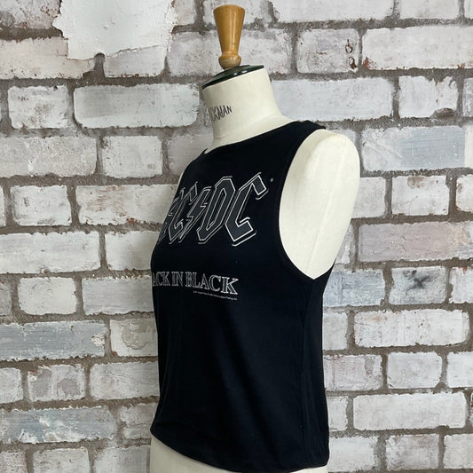 Black tank top with 'AC/DC Back in Black' design on a mannequin against a brick wall. AC/DC tank top, ACDC Back in black vest, ACDC sleeveless top, upcycled fashion by unwantees, recycled fashion, eco-friendly clothing UK, upcycled t-shirts