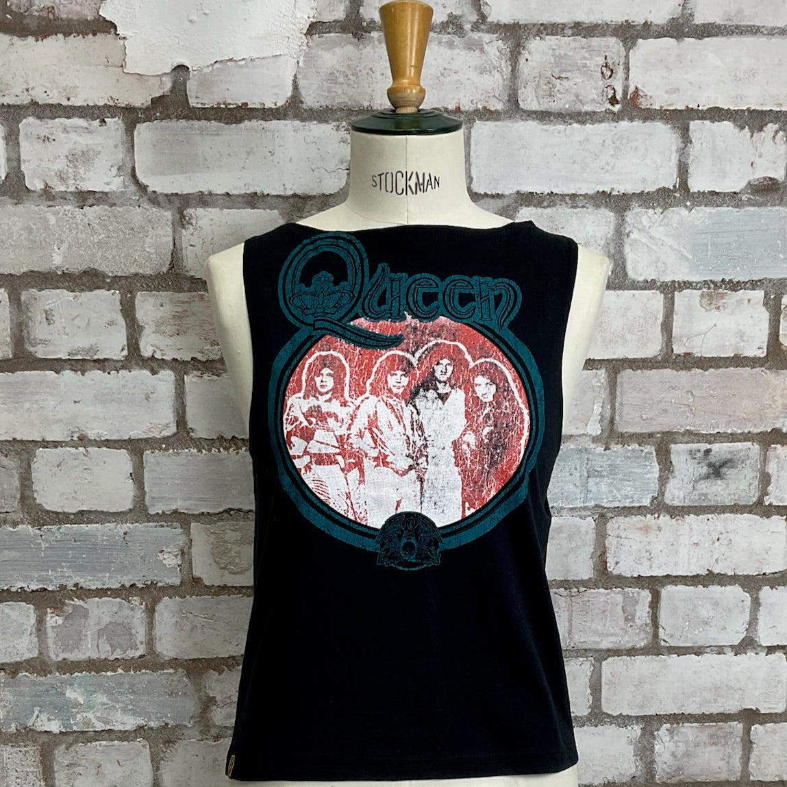 Black sleeveless shirt with Queen graphic design on a mannequin against a brick wall, Queen Tank Top, Vintage Queen Print Vest, Unwantees Upcycle