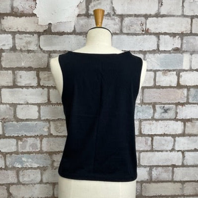 Black sleeveless top on a mannequin against a textured brick wall. Tank Top by Unwantees Slash Neck Style. www.unwantees.co.uk
