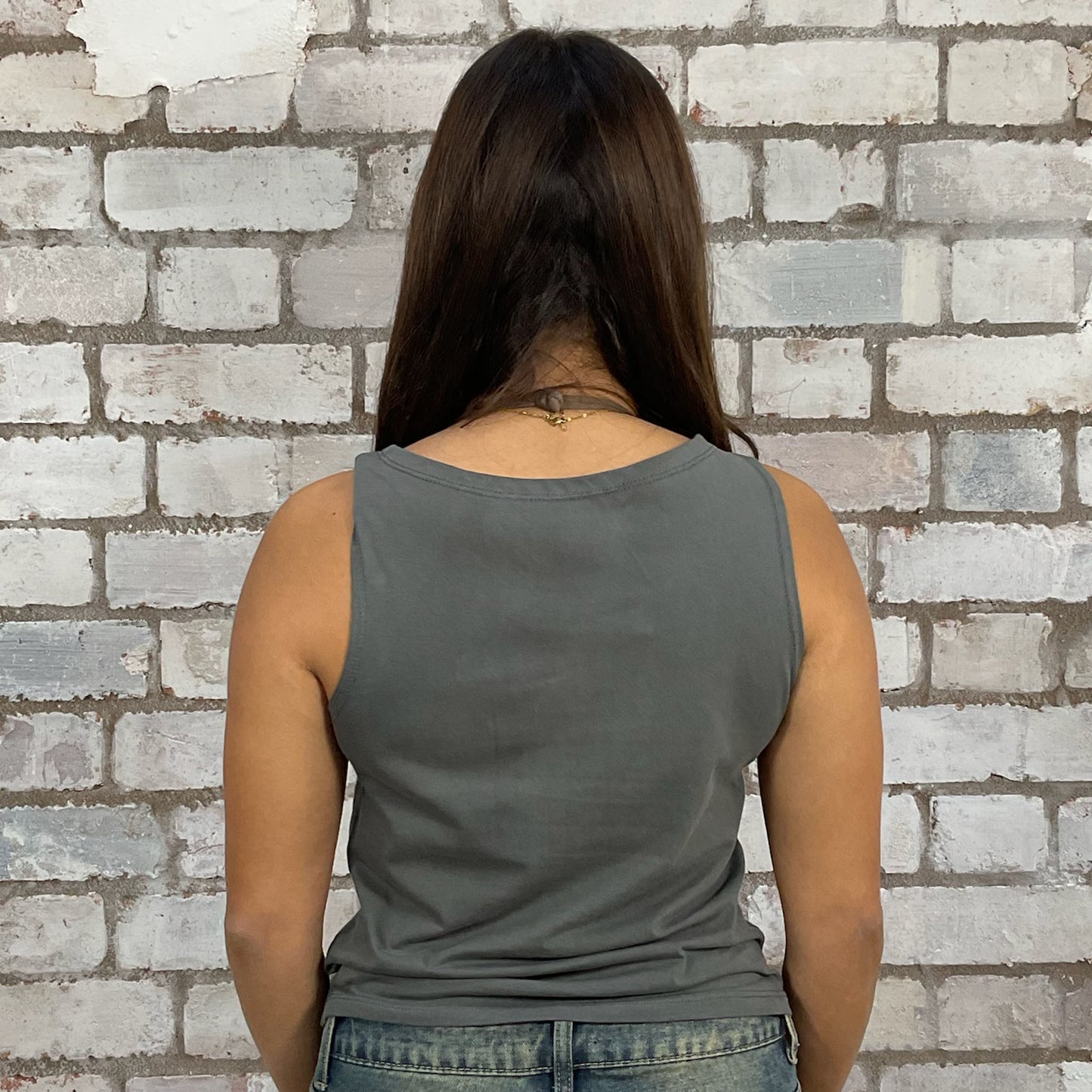 Person wearing a gray tank top against a brick wall, one-of-a-kind clothing
unique tank tops / unique vests
handmade clothing UK
reworked t-shirts UK
limited edition fashion
sustainable streetwear
sustainable tank tops
women’s eco fashion UK