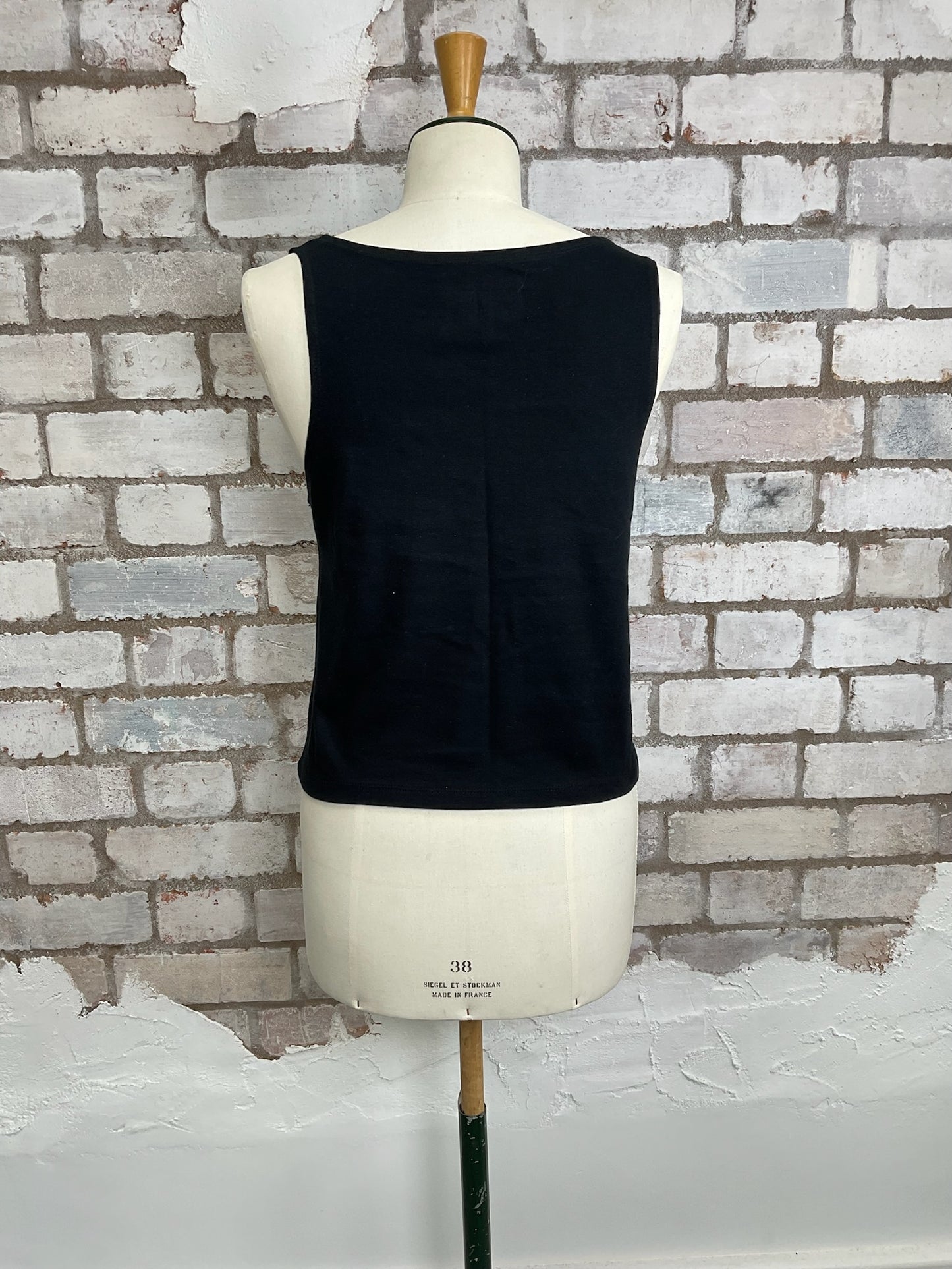 Black sleeveless top on a mannequin against a brick wall. sustainable fashion UK
eco-friendly clothing UK
upcycled t-shirts / upcycled tank tops
ethical fashion brand UK
zero waste clothing
slow fashion brand
made in Britain clothing
sustainable vest tops