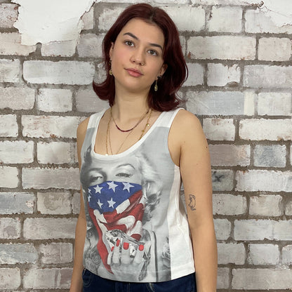 Marilyn Munroe Diamonds and USA Flag print tshirt upcycled by unwantees, atgleisurewear recycled clothing, sustainable clothing brand.  Woman wearing a tank top with a graphic design against a brick wall.