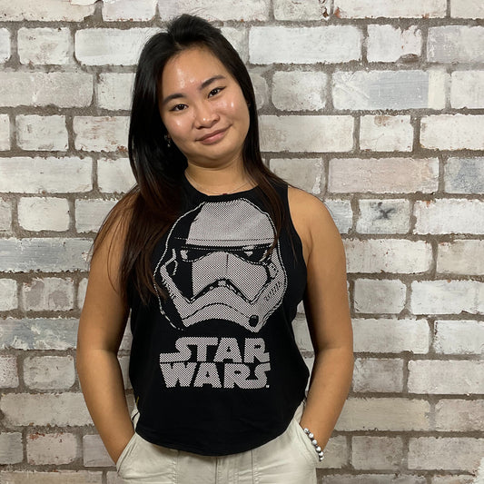 Person wearing a Star Wars tank top in front of a brick wall.  Storm Trooper Unwantee, recycled tank top made from preloved graphic tshirts, sustainable fashion, eco conscious shopping
