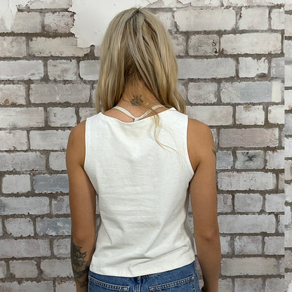 KISS band tshirt recycled into sleeveless racerback vest top, sustainable upcycled fashion, British recycled grunge brand, slow fashion, Punk Rock music style graphic tshirt upcycled by Unwantees, Pink text on cream tshirt upcycled in the UK by unwantees. Sustainable upcycled fashion. Graphic tshirt upcycled by Unwantees recycled tshirt otherwise destined for landfill.  