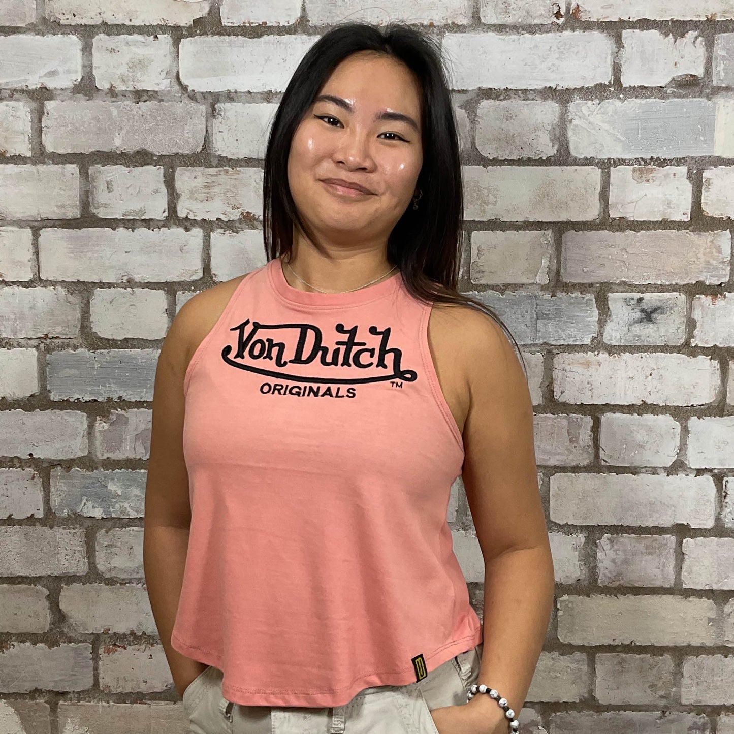 Von Dutch embroidered logo on peachy pink 100% cotton fabric, Unwantee made from upcycled and deconstructed graphic tshirt, punk rock style street wear, athleisure wear, unwantees is a sustainable fashion brand, we take unwanted graphic tshirts otherwise destined for landfill and recycle clothing into vest tops for sports wear or leisure.  Refashioned band merch, Slash Neck Sleeveless Top