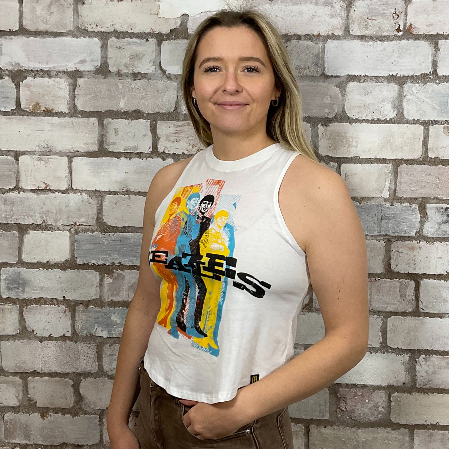 The Beatles Vibrant graphic band print on 100% white cotton fabric, Unwantee made from upcycled and deconstructed graphic tshirt, punk rock style street wear, athleisure wear, unwantees is a sustainable fashion brand, we take unwanted graphic tshirts otherwise destined for landfill and recycle clothing into vest tops for sports wear or leisure.  Refashioned band merch, Slash Neck Sleeveless Top