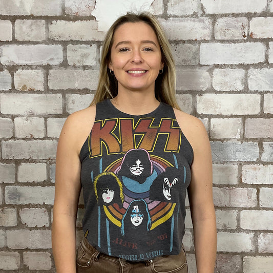 Person wearing a KISS tank top in front of a brick wall.  KISS Alive Tour 1997 tank top, World Tour KISS Tshirt Upcycle by Unwantees, KISS graphic tshirt, up cycle by Unwantees, www.unwantees.co.uk