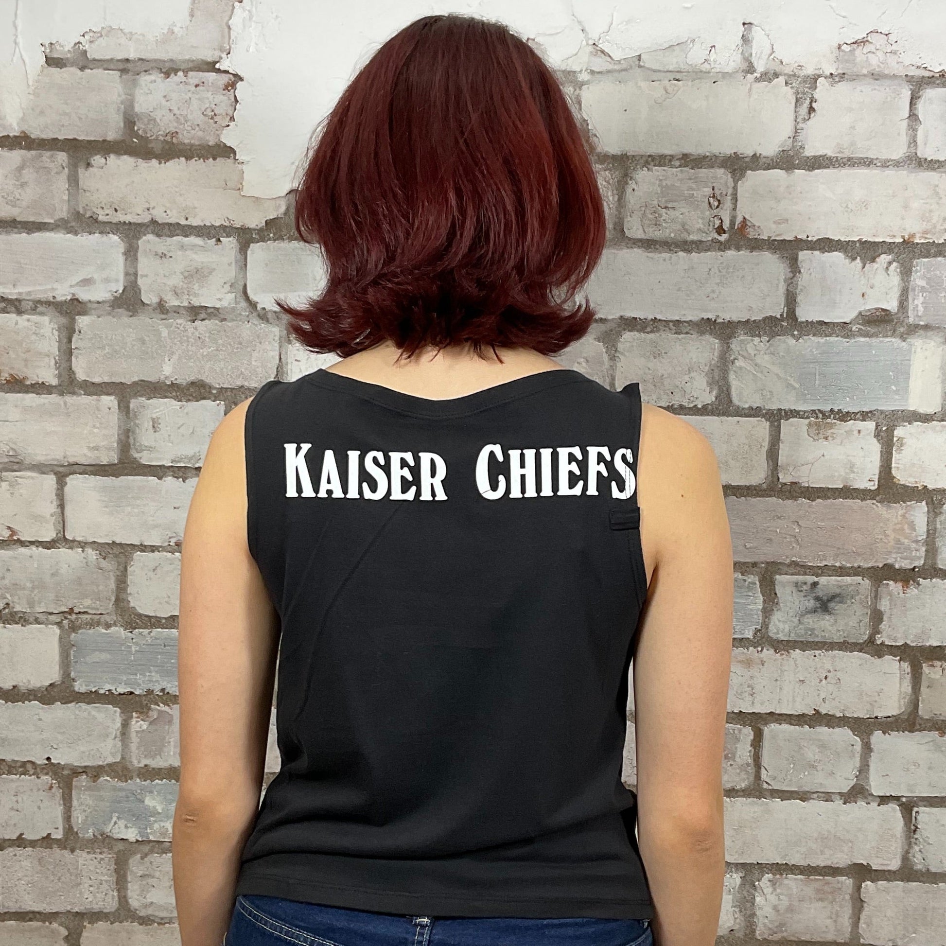 Kaiser Chiefs Band Double Sided white Graphic print on 100% black cotton fabric, Unwantee made from upcycled and deconstructed graphic tshirt, punk rock style street wear, athleisure wear, unwantees is a sustainable fashion brand, we take unwanted graphic tshirts otherwise destined for landfill and recycle clothing into vest tops for sports wear or leisure.  Refashioned band merch, Slash Neck Sleeveless Top