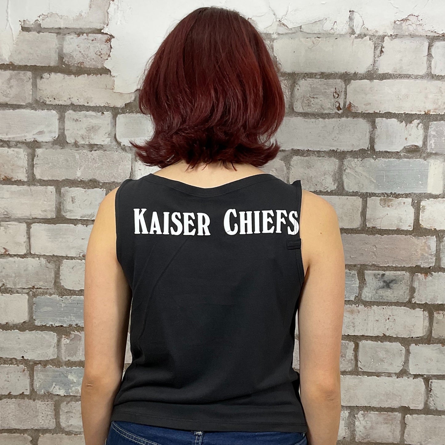 Kaiser Chiefs classic band logo graphic print ion 100% cotton fabric, black and white, Unwantee made from upcycled and deconstructed graphic tshirt, punk rock style street wear, athleisure wear, unwantees is a sustainable fashion brand, we take unwanted graphic tshirts otherwise destined for landfill and recycle clothing into vest tops for sports wear or leisure.  Refashioned band merch, Slash Neck Sleeveless Top