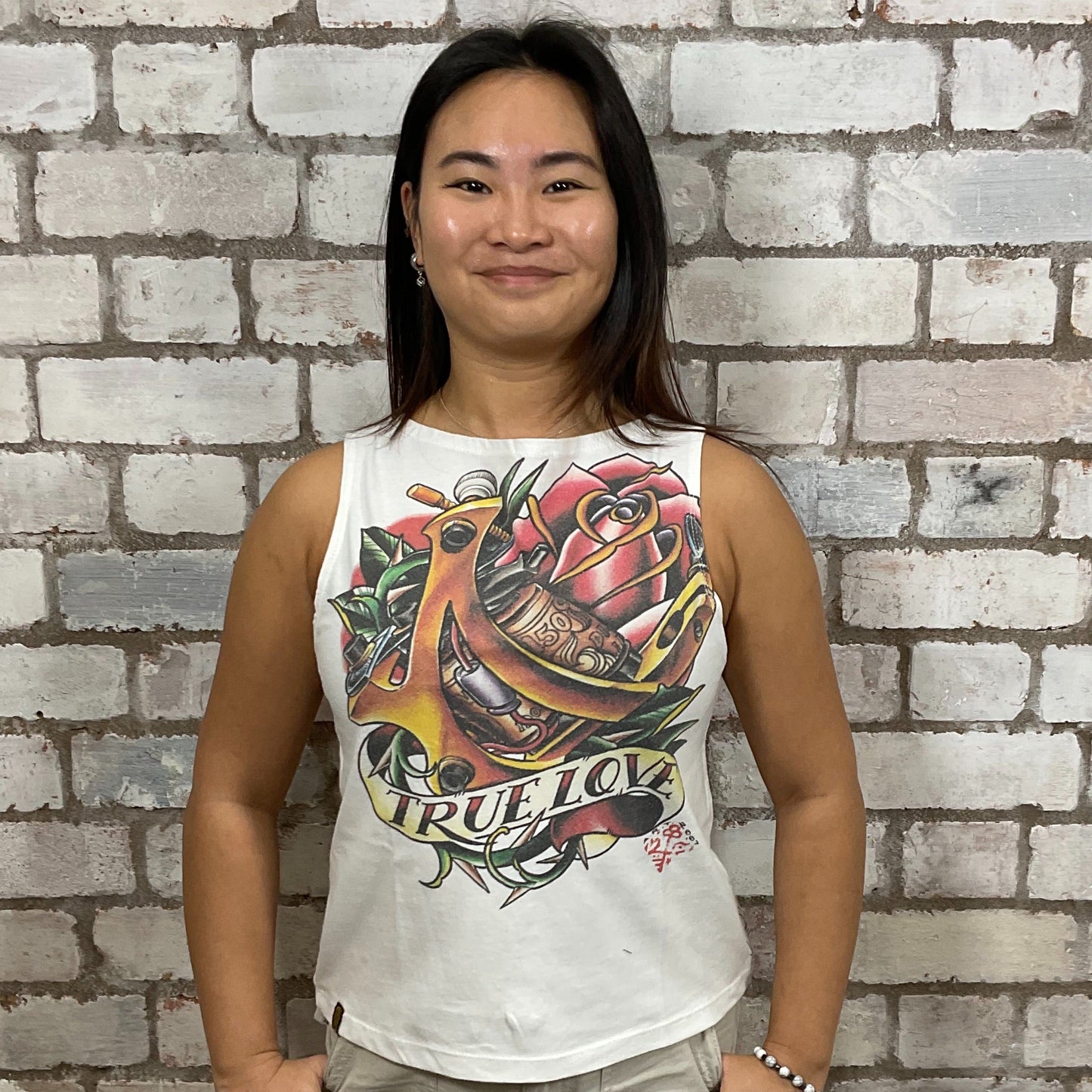 True love Tattoo Graphic print on 100% white cotton fabric, Festival Style Unwantee made from upcycled and deconstructed graphic tshirt, punk rock style street wear, athleisure wear, unwantees is a sustainable fashion brand, we take unwanted graphic tshirts otherwise destined for landfill and recycle clothing into vest tops for sports wear or leisure.  Refashioned band merch, Slash Neck Sleeveless Top