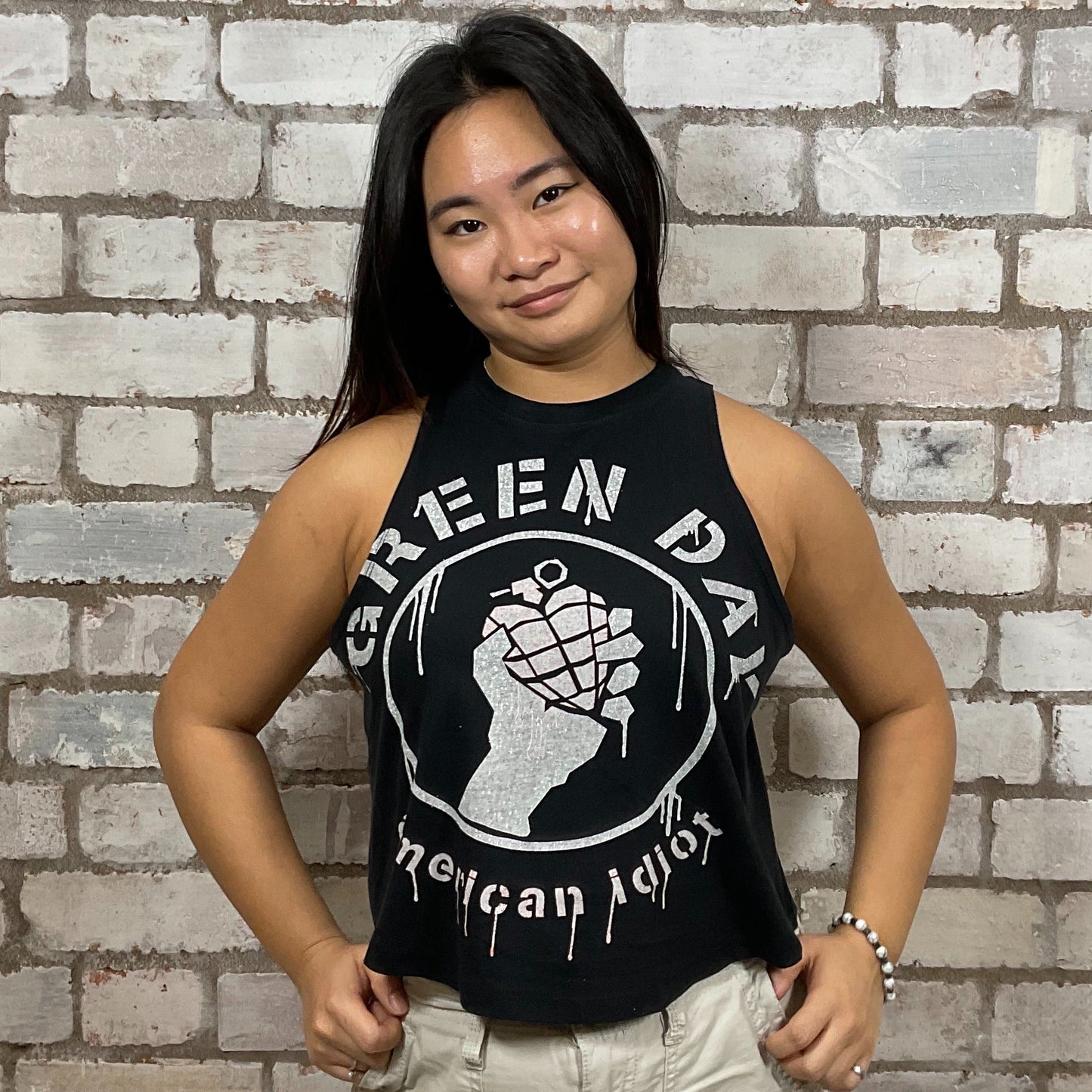 Green Day’s American Idiot Album Graphic print on 100% black cotton fabric, Festival Style Unwantee made from upcycled and deconstructed graphic tshirt, punk rock style street wear, athleisure wear, unwantees is a sustainable fashion brand, we take unwanted graphic tshirts otherwise destined for landfill and recycle clothing into vest tops for sports wear or leisure.  Refashioned band merch, Slash Neck Sleeveless Top
