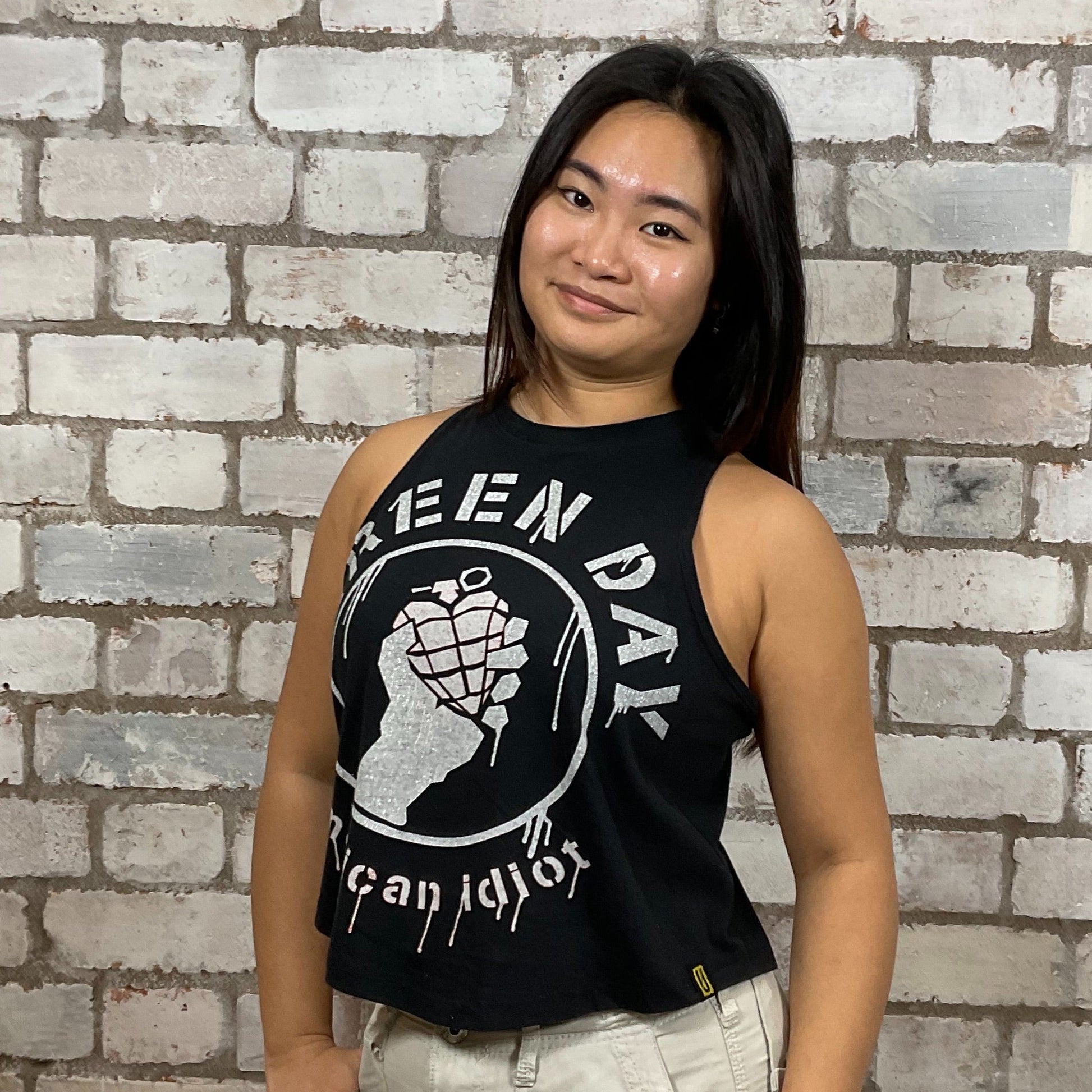 Green Day’s American Idiot Graphic print on 100% black cotton fabric, Festival Style Unwantee made from upcycled and deconstructed graphic tshirt, punk rock style street wear, athleisure wear, unwantees is a sustainable fashion brand, we take unwanted graphic tshirts otherwise destined for landfill and recycle clothing into vest tops for sports wear or leisure.  Refashioned band merch, Slash Neck Sleeveless Top