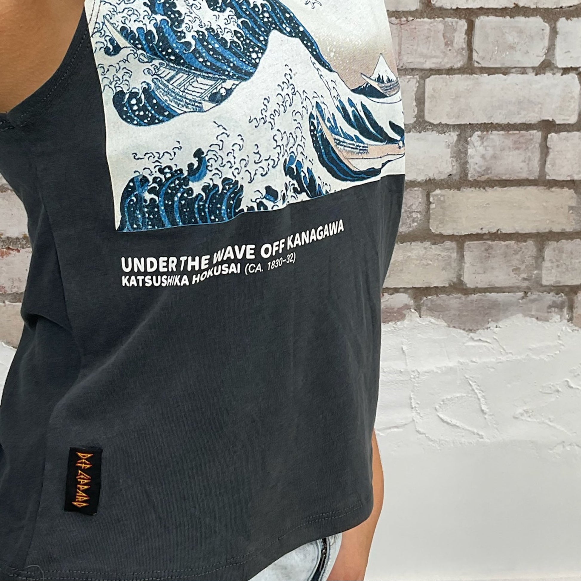London Met print of Katsushika Hokusai Under the Great Wave Off Kanagawa  print on dark grey graphic print tank top made from an upcycled graphic band tshirt, punk rock style street wear, athleisure wear, unwantees is a sustainable fashion brand, we take unwanted Y2K graphic tshirts otherwise destined for landfill and recycle clothing into vest tops for sports wear or leisure.  Refashioned band merch, Sleeveless Slash neck Top