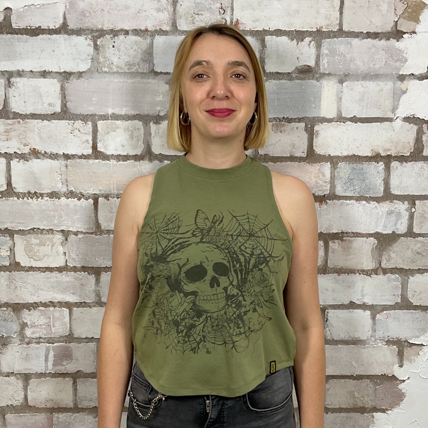 Skull Graphic tank top in Khaki Green with,  made from upcycled and deconstructed graphic tshirt, punk rock style street wear, athleisure wear, unwantees is a sustainable fashion brand, we take unwanted graphic tshirts otherwise destined for landfill and recycle clothing into vest tops for sports wear or leisure.  Refashioned band merch, Slash Neck Sleeveless Top