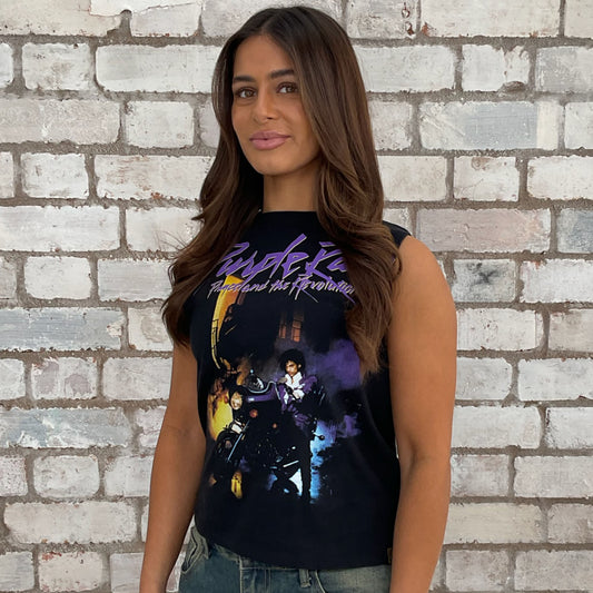 Woman wearing a Prince sleeveless graphic t-shirt in front of a brick wall. one-of-a-kind clothing
unique tank tops / unique vests
handmade clothing UK
reworked t-shirts UK
limited edition fashion
sustainable streetwear
sustainable tank tops
women’s eco fashion UK
