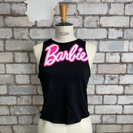 Black tank top with pink 'Barbie' text on a mannequin against a brick wall.  Barbie Tank Top, Barbie vest Top, Barbie life is fantastic in plastic, Unwantees slash neck style, recycled up cycle fashion