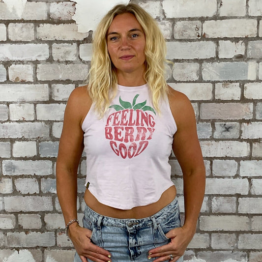 Woman wearing a 'Feeling Berry Good' tank top in front of a textured brick wall.  Feeling Berry Good Unwantee, tank top, vest top, recycled fashion by Unwantees