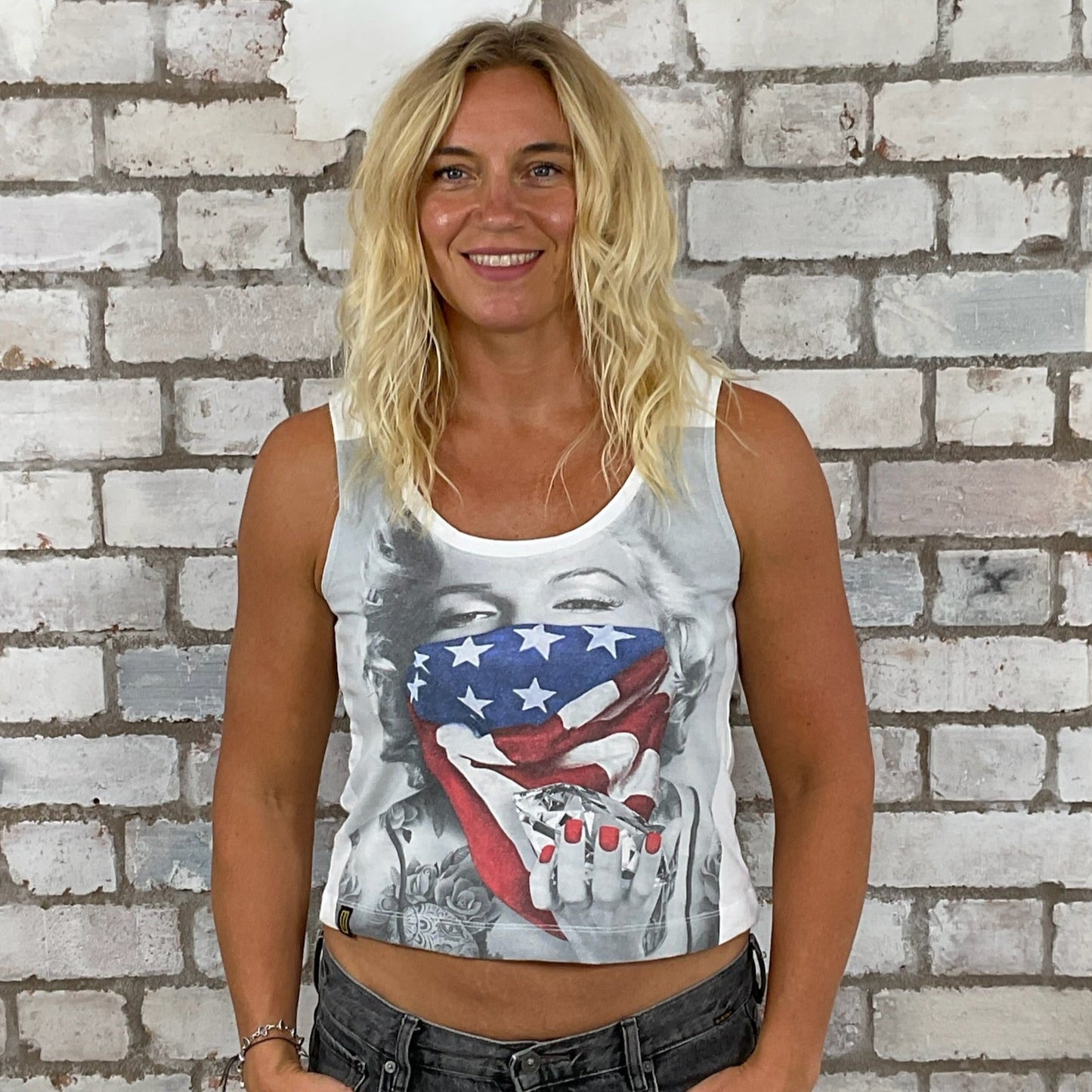 Woman wearing a tank top with a graphic design in front of a brick wall.  Athleisure wear,  Marilyn Munroe tank top, Diamonds are a girls best friend, unwanee, tank top, vest top, street wear, yoga top, Sports top, USA flag