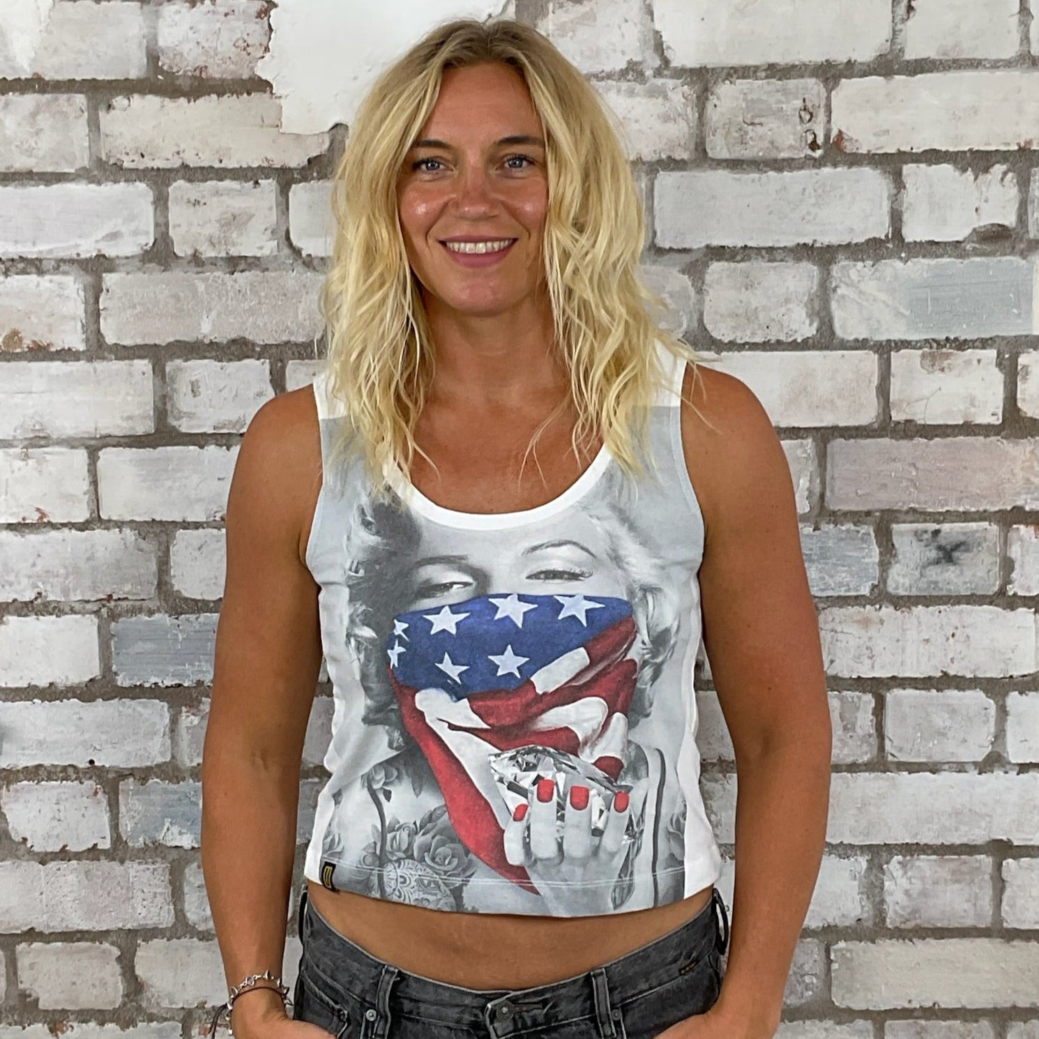 Woman wearing a tank top with a graphic design in front of a brick wall.  Athleisure wear,  Marilyn Munroe tank top, Diamonds are a girls best friend, unwanee, tank top, vest top, street wear, yoga top, Sports top, USA flag