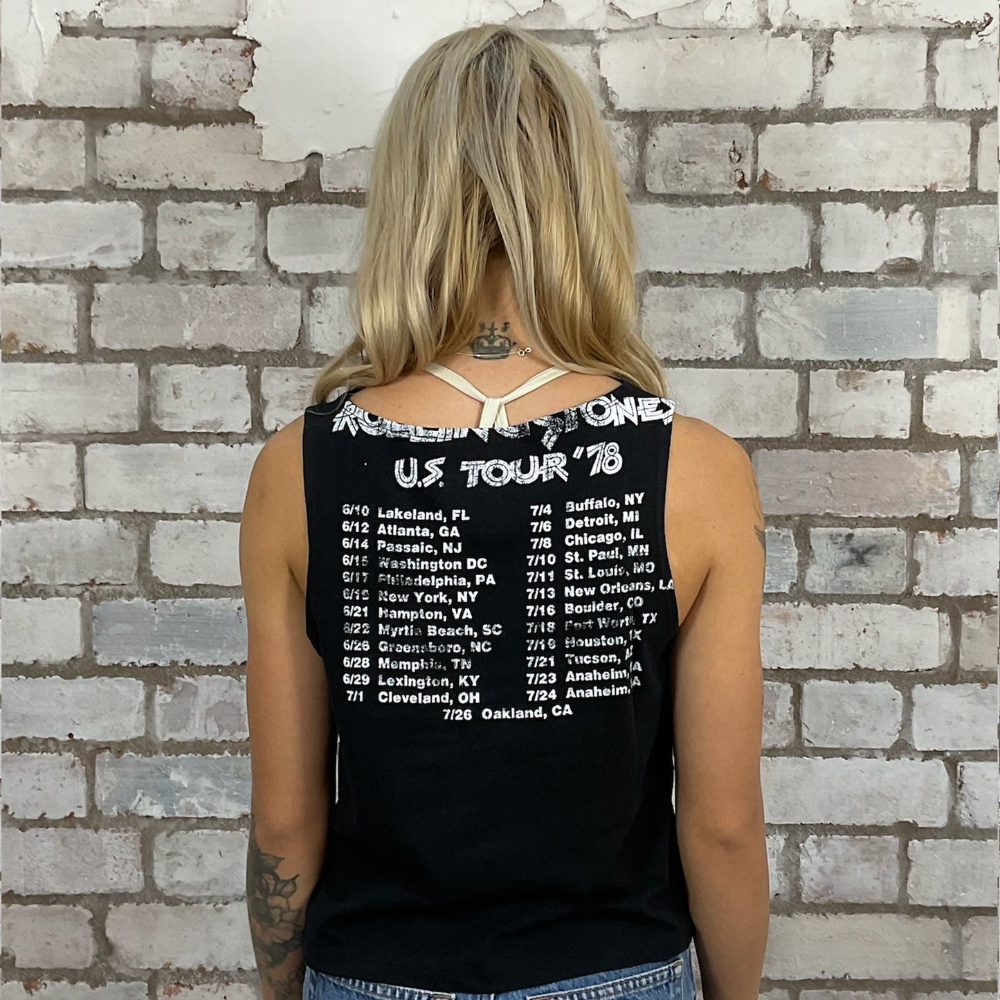 Person wearing a black tank top with Rolling Stones tour details.  A modern upcycle by Unwantees