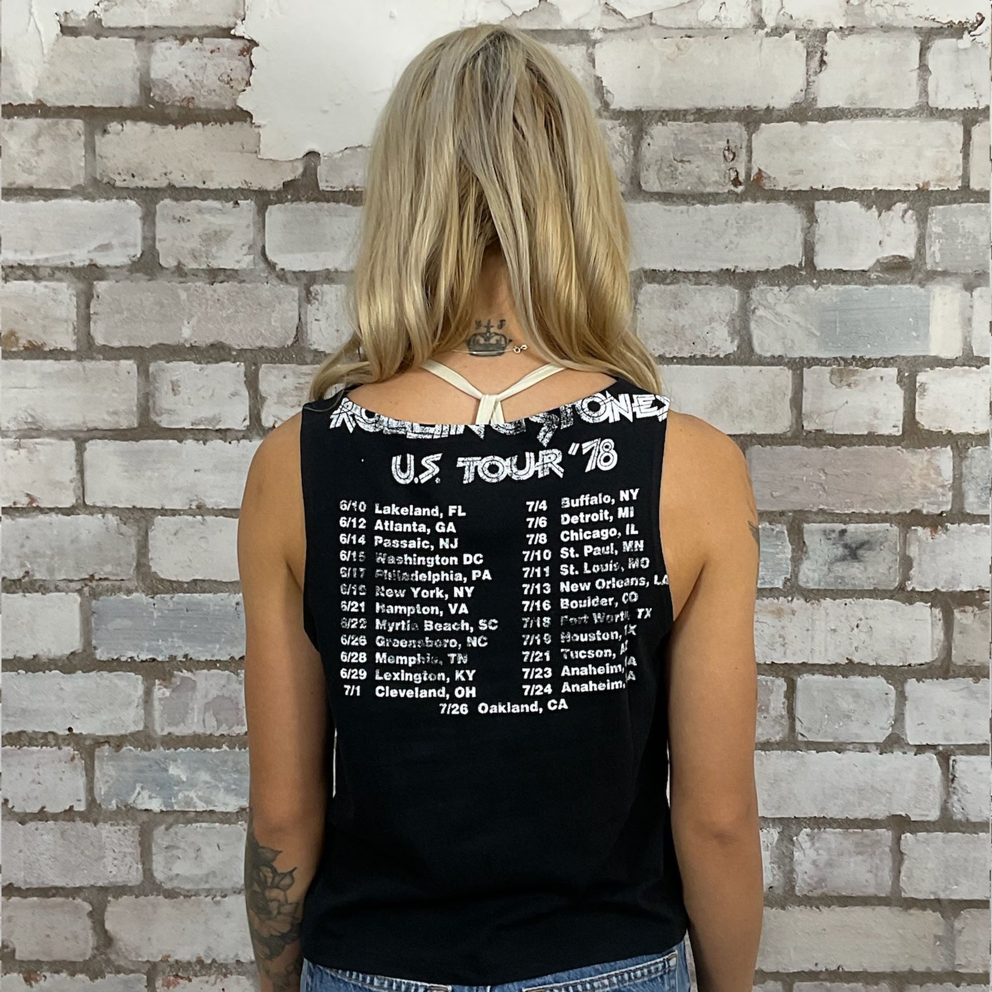 Person wearing a black tank top with Rolling Stones tour details.  A modern upcycle by Unwantees