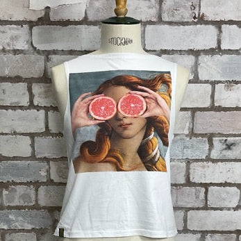 Mannequin wearing a white garment with a graphic design against a brick wall.   The Madonna fun Clementine graphic tank top recycled tshirt by Unwantees