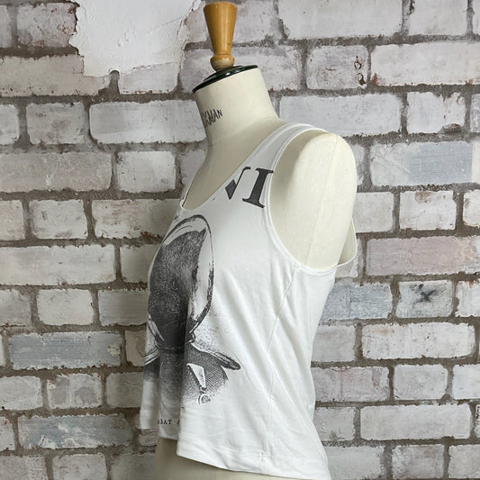 White sleeveless top with elephant design on a mannequin against a brick wall.  White tank top with graphic design on a mannequin against a brick wall.  Wombat Astronaut, Plini Band Tshirt, Plini Tank Top, Plini Vest Top, Plini Tank Top, Wombat print tank top