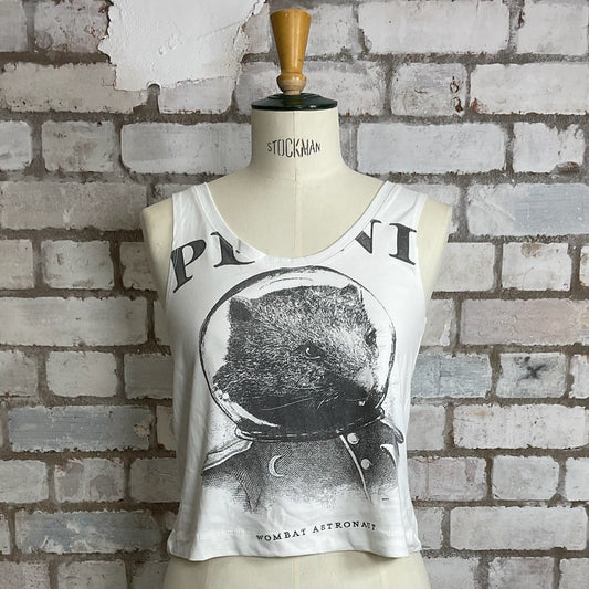 White tank top with graphic design on a mannequin against a brick wall.  Wombat Astronaut, Plini Band Tshirt, Plini Tank Top, Plini Vest Top, Plini Tank Top, Wombat print tank top